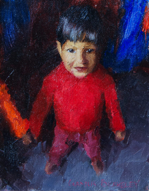 Oil painitng of a young boy living in Bikaner, Rajasthan, India in a bright red sweater looking upward.