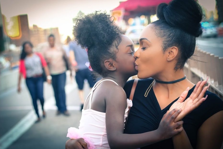 A mother and daughter embrace.